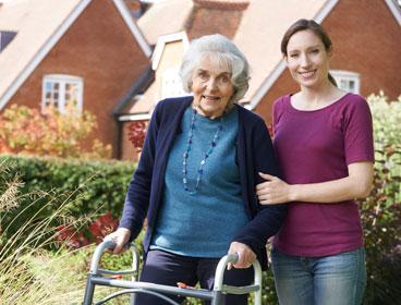 caregiver-with-standing-woman